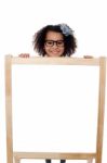 Girl Peeping From Behind White Writing Board Stock Photo