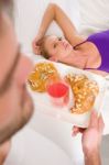 Lady On Bed Man Serving Breakfast Stock Photo