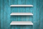 Three White Shelves On Blue Wooden Interior Texture Background Stock Photo