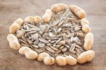 Sunflower And Peanut Seeds On Weathered Wood Stock Photo