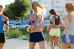 Group Of Women Running In The Park Stock Photo