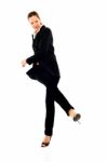 Businesswoman Kicking Stock Photo