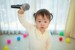 Little Asian Girl With Microphone Stock Photo