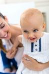 Baby Girl And Her Mother Playing At Home Stock Photo