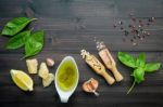 The Ingredients For Green Pesto Sauce On Dark Wooden Background Stock Photo