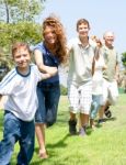 Happy Family Making Chain Stock Photo