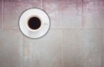 Top View Of Coffee Cup On Ceramic Tiles Wall Background Stock Photo