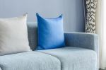 Modern Green Sofa With Blue And Grey Pillows Stock Photo