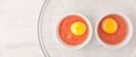 Raw Eggs With Tomatoes In The Ramekins On The White  Wooden Table Wide Screen Stock Photo