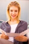 Close-up Of A Smiling Woman Holding Card Stock Photo