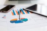 Financial Charts On The Table With Tablet And Pen Stock Photo