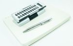 Pocket Calculator And Pen On The Table Stock Photo