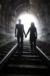 Couple Walking Together Through A Railway Tunnel Stock Photo