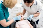 Little Girl Examined By Dentist And Her Assistant Stock Photo