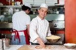 Chefs At Work Inside Restaurant Kitchen Stock Photo