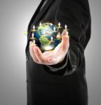 Business Man Holding The Small World In His Hand Stock Photo