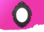 Oval Black Picture Frame With A Decorative On Pink Wall Stock Photo