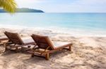 Beach Chairs On The White Sand Beach With  Blue Sky And Sun Stock Photo