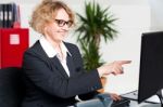 Woman Pointing At Computer Screen Stock Photo