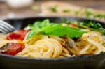 Spaghetti Pasta With Baked Cherry Tomatoes And Basil Stock Photo