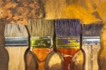 Oil Paint Brushes On Wood Painted Background Stock Photo