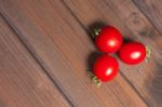 Fresh Tomatoes On The Dark Wooden Table Stock Photo