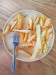 Traditional French Fries On Wood Background Stock Photo