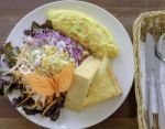 Omelet With Mix Vegetable Salad And Thick Bread Breakfast Stock Photo