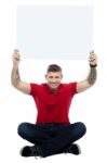 Man Sitting On Floor With Board Stock Photo