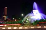 The Fountain At The City Intersection With The Building's Background Towering High Behind Stock Photo