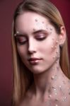 Girl With White And Pearl Rhinestones On Her Face Stock Photo