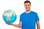 Young Male Holding Globe Stock Photo