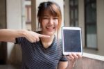 Portrait Of Thai Adult Beautiful Girl Using Her Tablet Stock Photo