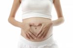 Hand On Abdomen Of Pregnant Woman On White Background Stock Photo