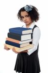 Unhappy School Girl With Pile Of Books Stock Photo