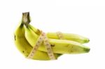 Measuring Tape Wrapped Around Bananas. Concept Of Diet Stock Photo