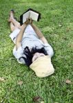 Young Woman Reading A Book In Park Stock Photo