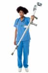 Orthopedic Lady Doctor With Crutches In Hand Stock Photo