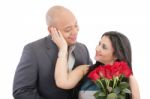 Happy Woman Receiving A Bouquet Of Red Roses Of Her Lover Stock Photo