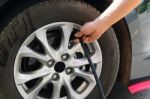 Inflating The Automobile Wheels Via A Pump Stock Photo