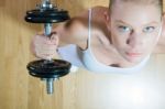 Woman Lifting Dumbbell In Gym Stock Photo