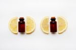 Lemon Slices With Bottle Of Lemon Essential Oil On  White Stock Photo