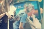 Young Woman With Tablet Computer Walking On Street Stock Photo