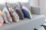 Colorful Pillows On Modern Grey Sofa Stock Photo