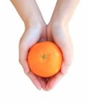 Hands Holding Orange Stock Photo