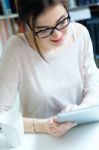 Young Worker Woman With Digital Tablet In Her Office Stock Photo