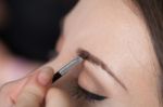 Close Up Of A Woman Putting On A Make Up Stock Photo