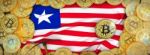 Bitcoins Gold Around Liberia  Flag And Pickaxe On The Left.3d Il Stock Photo