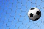 Football In Goal Net Stock Photo