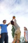 Happy Young Family, Father And Son Playing Ball In The Park Stock Photo